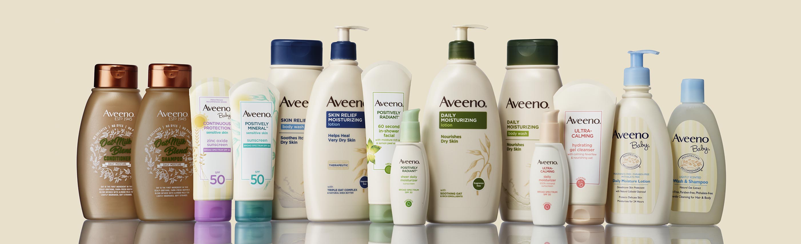 Aveeno products lined up with sunscreen, haircare, skin relief lotion, positively radiant, ultra calming and baby 
