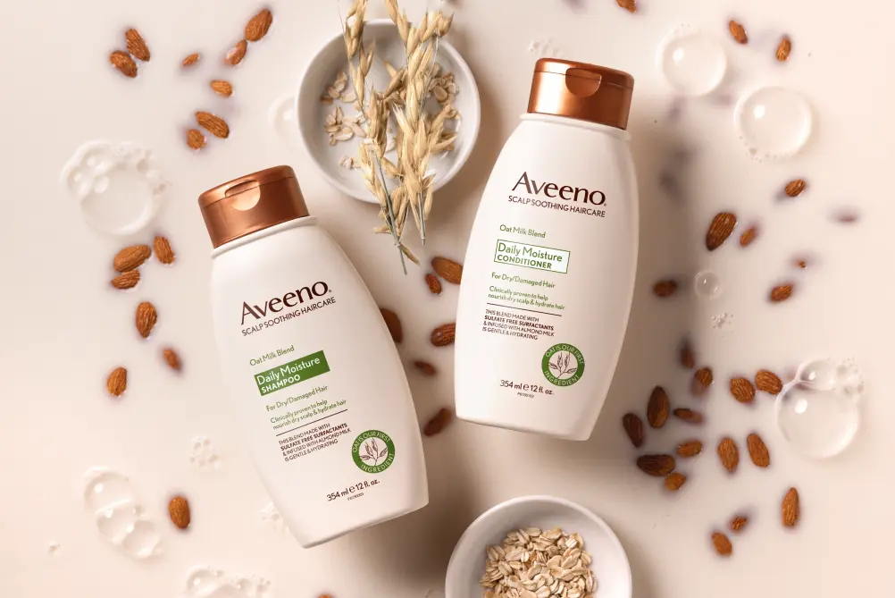 Aveeno® Daily Moisture haircare set displayed with its nourishing ingredients fit for all hair types