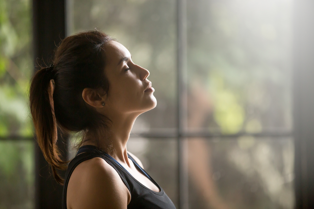 Woman breathing while meditating