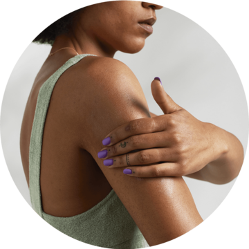 Woman touching shoulder with Eczema