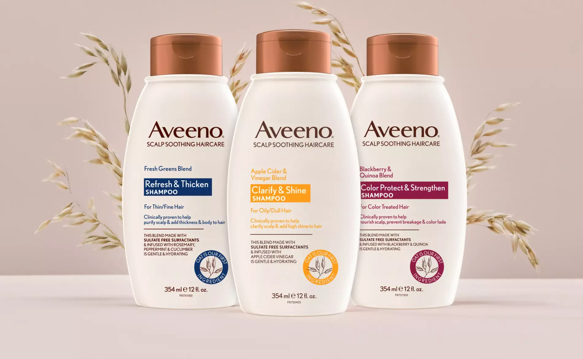 Three bottles of Aveeno® Scalp Soothing Haircare are displayed in front of a bunch of oats plants