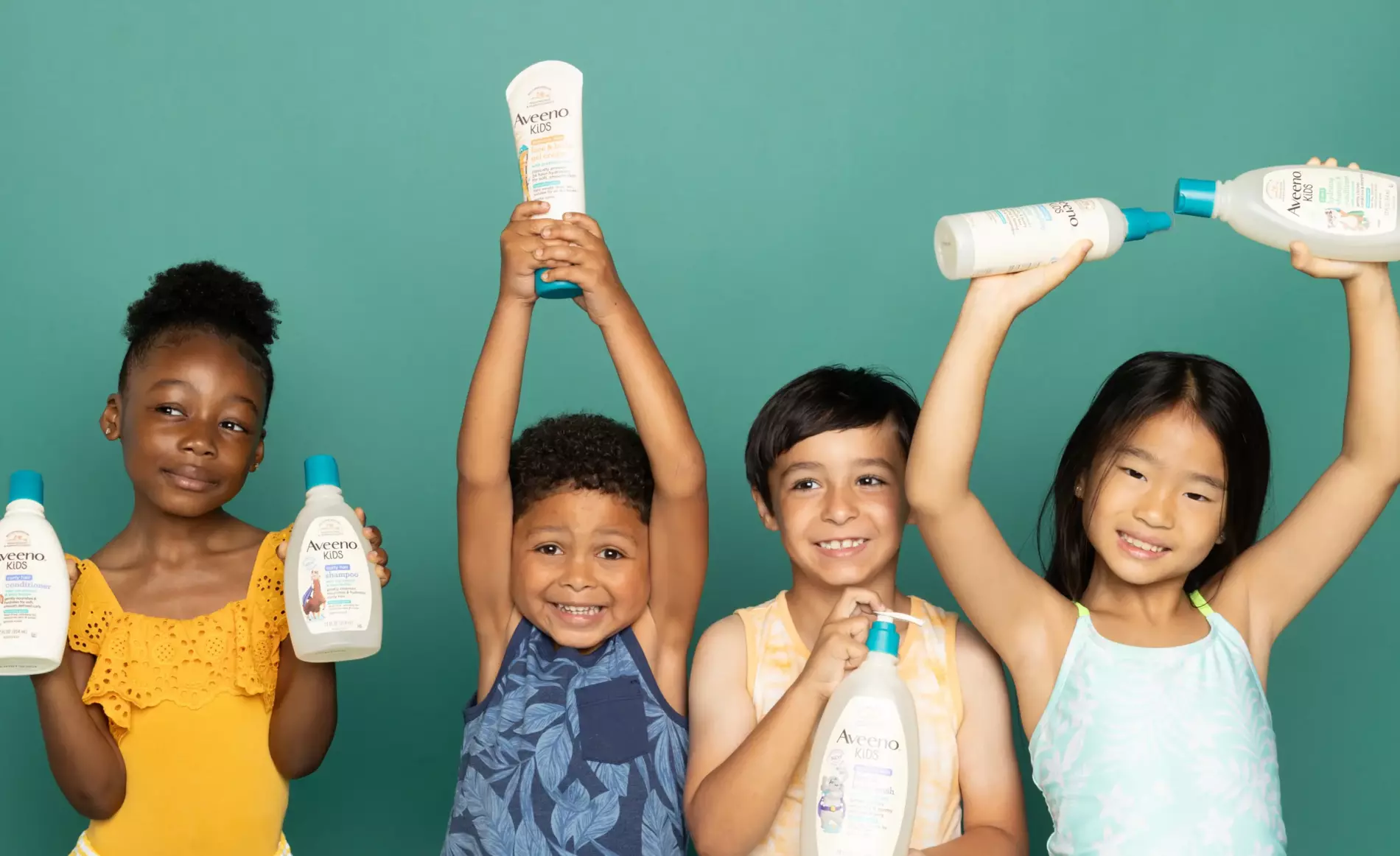 a group of children are holding Aveeno Kids products
