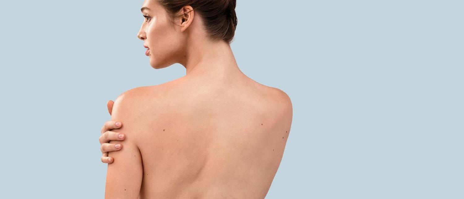 Woman standing with bare back showing