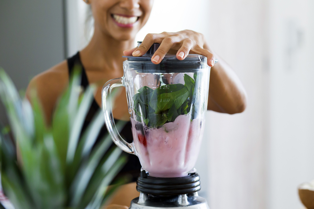 Woman blending a smoothie.